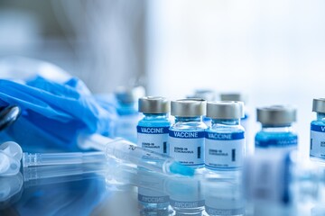 Fight the coronavirus, sars-cov-2 pandemic. Ampoules with Covid-19 vaccine on a laboratory bench.