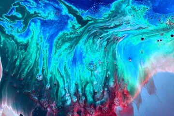 Abstract black-green-blue marble background. Acrylic paint flows freely and creates an interesting...
