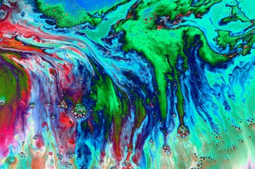 Abstract black-green-blue marble background. Acrylic paint flows freely and creates an interesting...