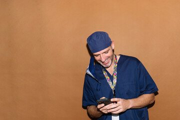 Studio portrait of smiling doctor with smartphone / healthcare worker