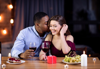 Portrait Of Affectionate Interracial Couple Having Romantic Date In Restaurant