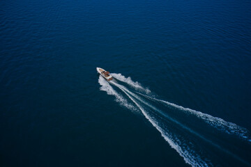 Top view of the boat. Aerial view luxury motor boat. Top view of a white boat sailing in the blue...