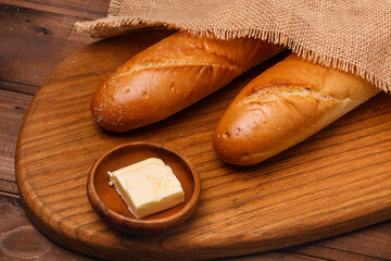 Fresh baguette bread on wooden background