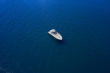 Yacht on blue water. Top view of the boat. Aerial view luxury motor boat.