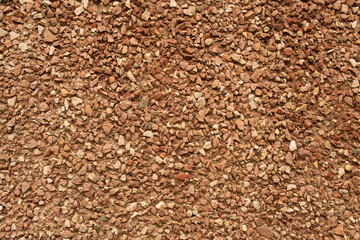 A view of a wall with a texture of small brown stones.