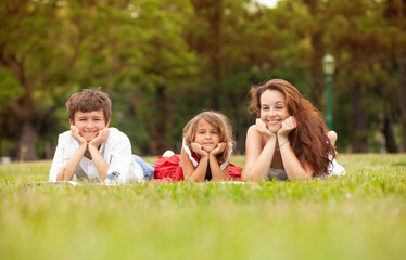 Fototapeta premium happy mother with children in the park outdoors