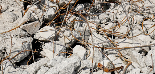Demolitions: reinforced concrete wall destroyed with visible rusty armor