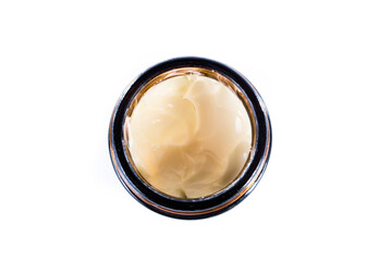 Open jar of hand cream from above on white background