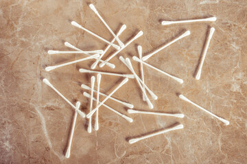 Heap of scattered hygiene sticks on marble background