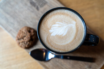 Beautiful cappuccino with a pattern of thick milk foam - the work of a professional barista
