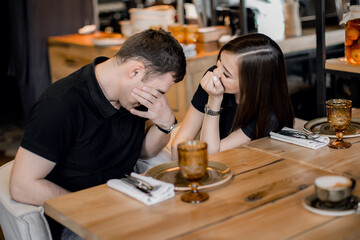 happy loving couple guy and girl on a date in a cafe