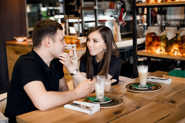 happy loving couple guy and girl on a date in a cafe
