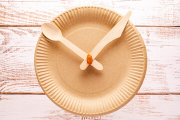 disposable plate, spoon and fork in the form of clock