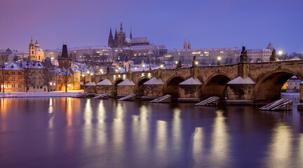 charles bridge and prague castle / winter morning with snow