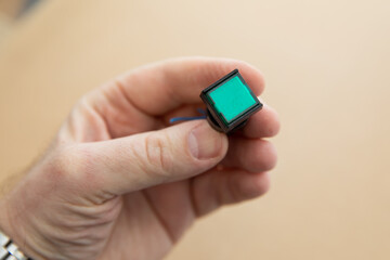 A color button with a lamp for old radio equipment. Warning lights on the control panel.