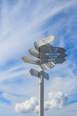 Sign indicating the directions and distances to major cities in the world on observation deck on a top of Tahtali mountain near Kemer, Antalya Province in Turkey