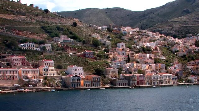 Symi Greece Rhodes is a Greek island It is mountainous and includes the harbor town of Symi and its adjacent upper town Ano Symi, with beautiful neoclassical uniform and colorful houses