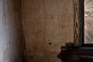 Fototapeta na wymiar A dark room with dust and dirt float in the air, in an old house. The specks of dust show motion