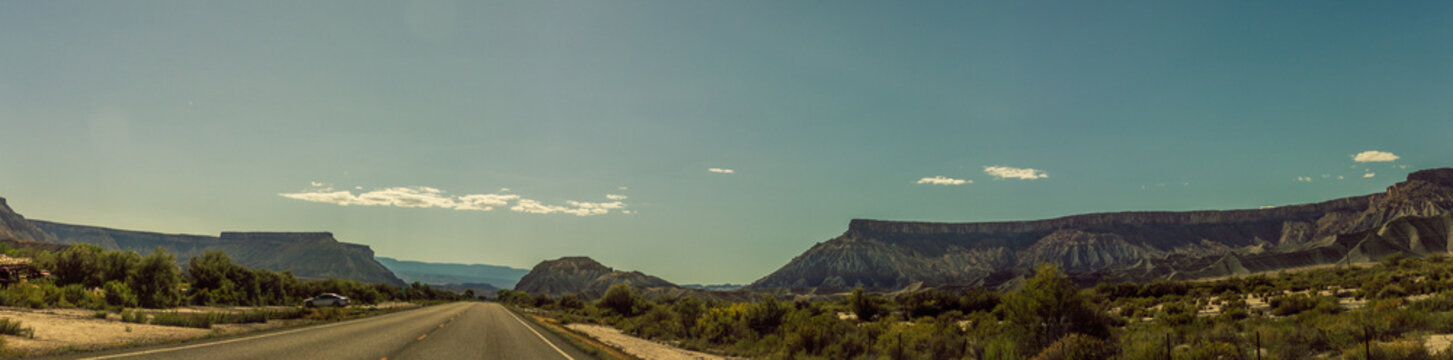 Panorama shot of straight road and american anture in Capitol Reef national park in Utah