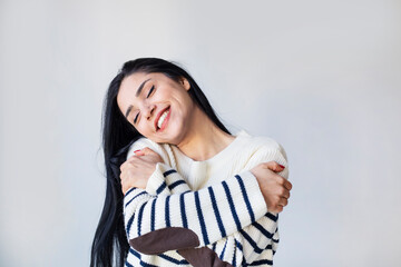 young beautiful woman feeling in love, smiling, cuddling and hugging self, staying single, being...