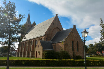 Fototapeta na wymiar Sint Jacobus Church in Renesse, Zeeland, Netherlands with sun