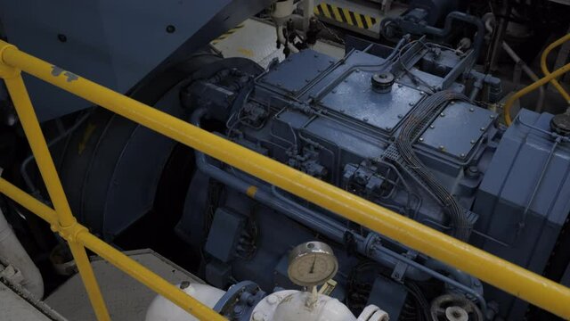 Gear of shaft generator next to engine of ship