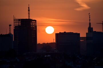 Silhouette of city center with construction on going and the  sun set