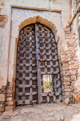 Fototapeta na wymiar Door with spikes against elephants at a gate of Taragarh Fort in Bundi, Rajasthan state, India