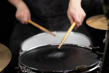 Professional drum set closeup. Man drummer with drumsticks playing drums and cymbals, on the live...