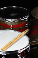 Closeup of drumsticks lying on the professional drum set. Drummer equipment. 