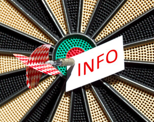 a white sheet of paper labeled with the word "info", fixed by  an arrow on a dartboard