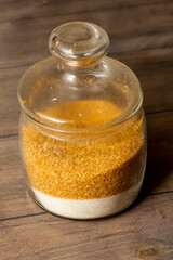 brown and white sugar in a glass jar