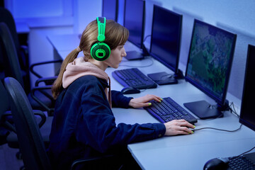 A professional gamer plays and wins a first-person game online on his personal computer. © Evgenia