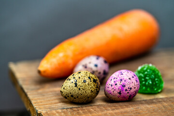 Celebrating Easter. quail eggs, marmalade and carrots on a wooden table.
