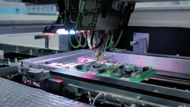 Automation machine equipment for quality testing of printed circuit boards - flying probe test at factory. Automated technology, industrial, robotic, electronic, production, manufacturing concept