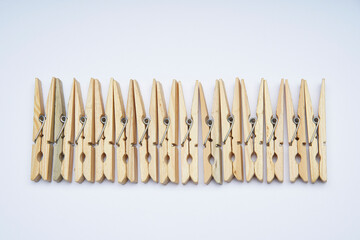 Wooden clothespin isolated on a withe background. The clothespin is a fastener used to dry clothes.