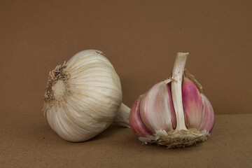 Fresh garlic isolated on brown background. Raw whole garlic closeup