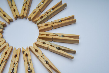 Wooden clothespin isolated on a withe background. The clothespin is a fastener used to dry clothes.