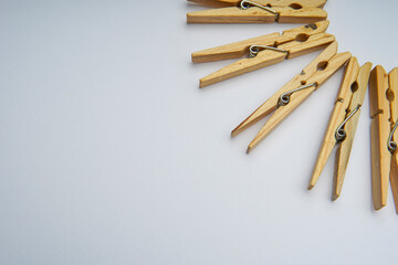 Wooden clothespin isolated on a withe background. The clothespin is a fastener used to dry clothes.