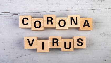 wooden blocks  in a white and grey board with the text corona virus