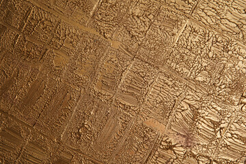 Fototapeta premium Rough gold colored surface. Empty space for text
