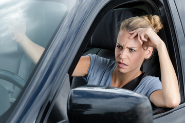 stressed woman upset about traffic in a new car