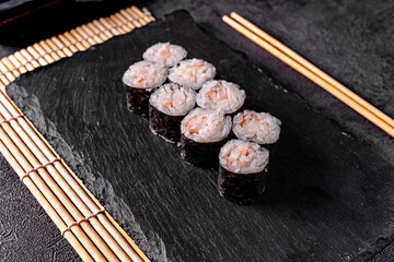 Classical roll sushi with crab sticks on black background for menu. Japanese food
