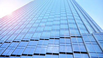 Fototapeta na wymiar Downtown corporate business district architecture. Glass reflective office buildings against blue sky and sun light. Economy, finances, business activity concept. Rising sun on the horizon.