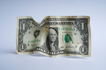 Financial crisis, crumpled one dollar banknote, US dollars on the white table. Bank image and commercial photo background.