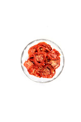 Closeup Dried cherry tomatoes from above on a wooden background, cut slices and whole tomatoes.