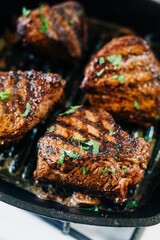 Four Pan Seared Filet Mignon Steaks cooked on a cast iron grill pan