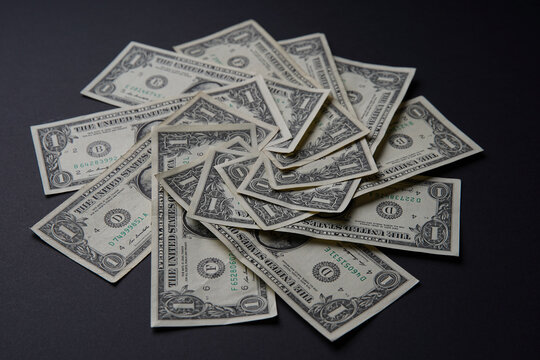 Pile of american dollars cash on black table. Bank image and photo background.