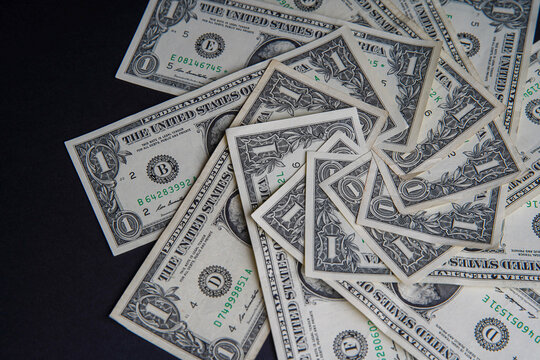 Pile of american dollars cash on black table. Bank image and photo background.
