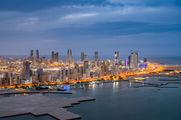 Aerial view of Manama city skyline at twilight and newly constructed areas in Manama, Bahrain.